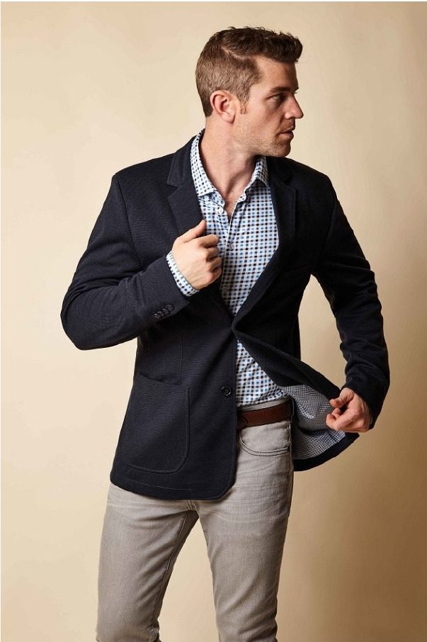 Male fit model Joe Cummings presenting a navy blazer and checked shirt